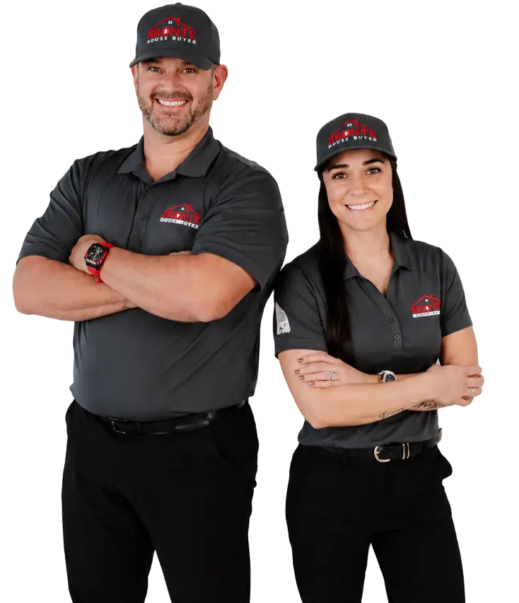 Jeremy and Cristine with arms crossed, wearing Bronte House Buyer caps