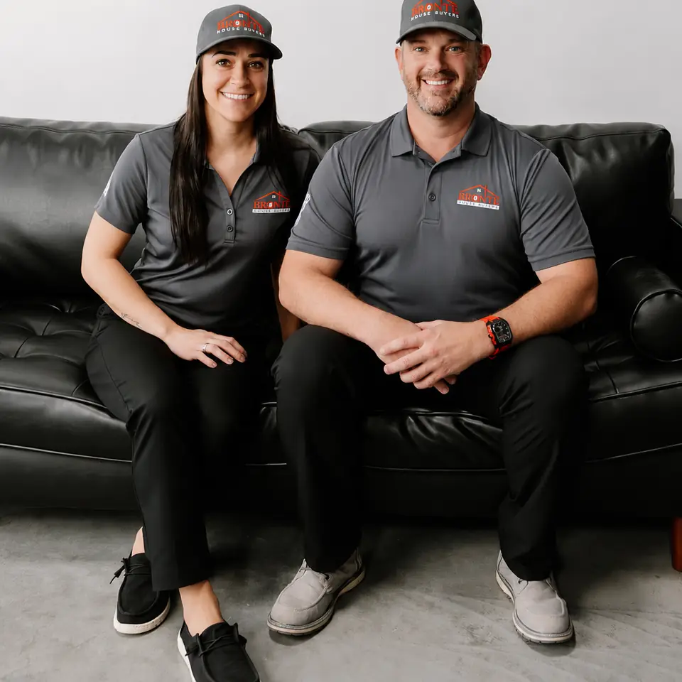 Jeremy and Cristine sitting side by side on a sofa in Bronte House Buyer caps
